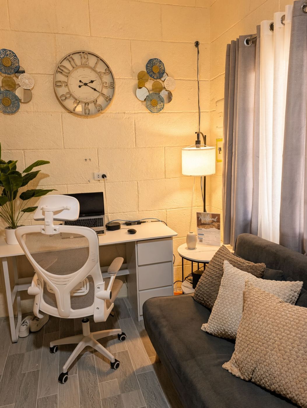 Living room with desk, office chair and grey sofa