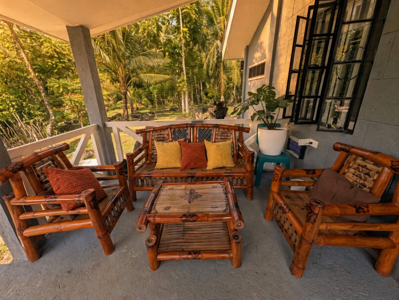 Covered porch with bamboo chairs and plants