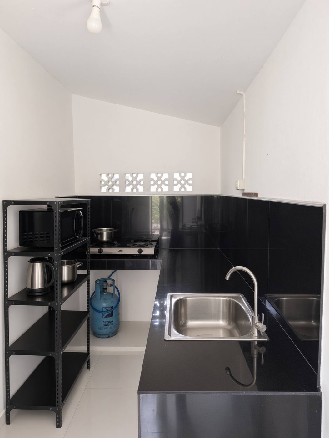 Kitchen with sink and open shelving