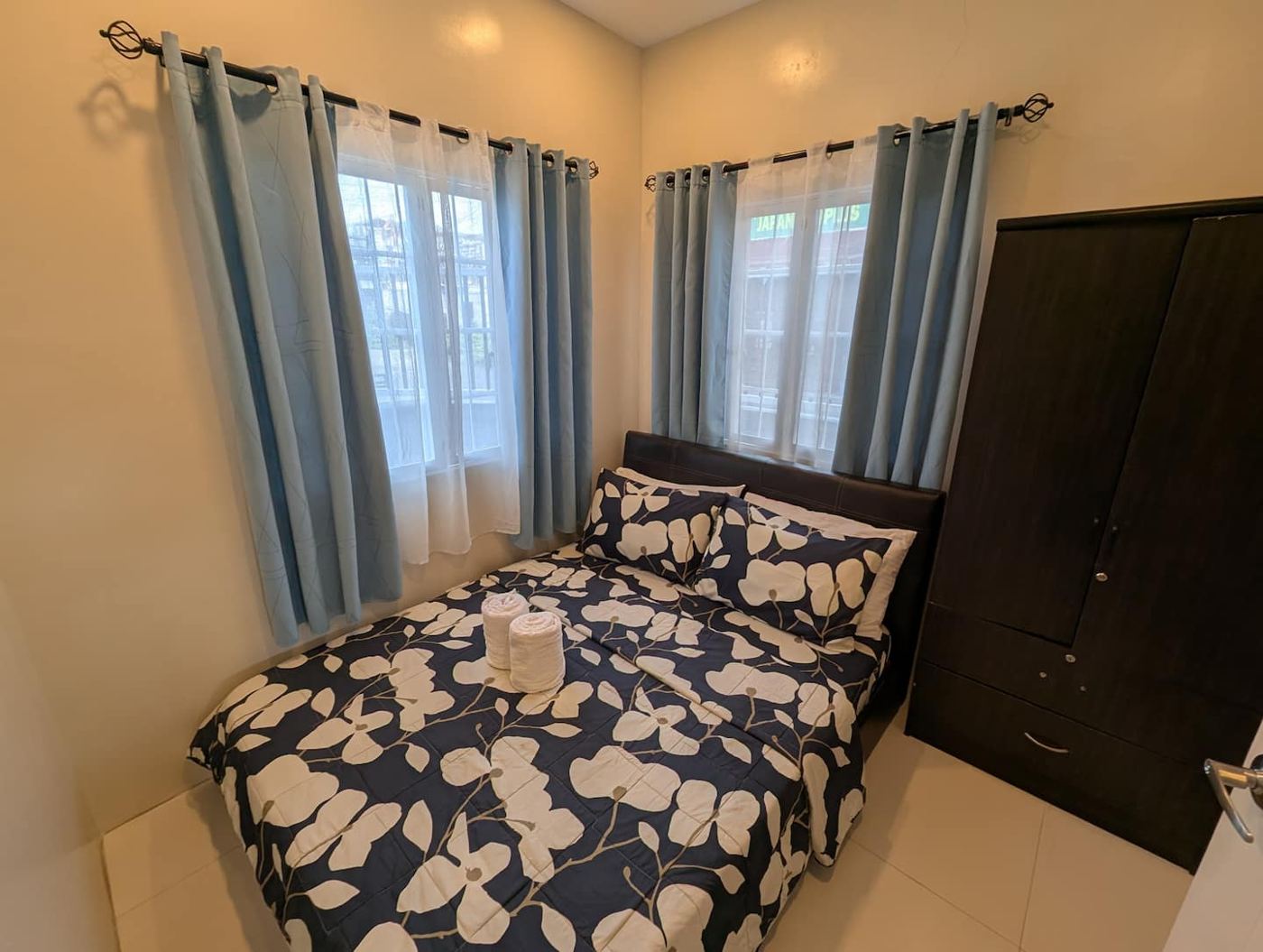 Bedroom 1 with queen bed and patterned duvet