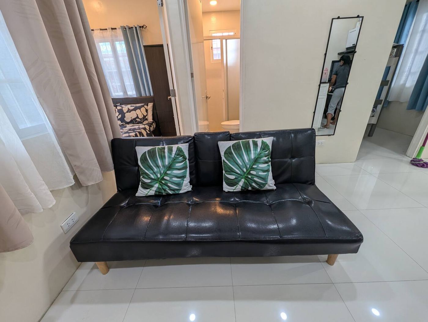 Living area with black futon sofa