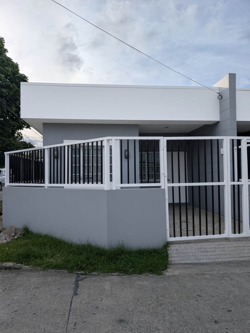 Front of the duplex with white gate