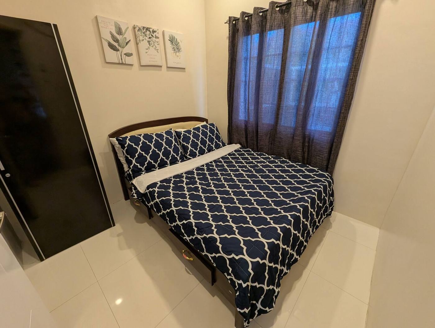 Primary bedroom with navy-and-white duvet