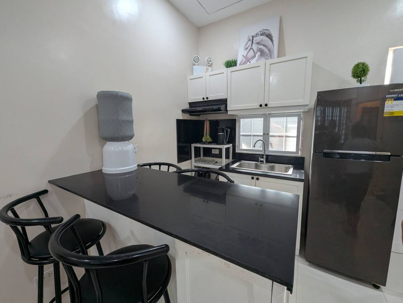 Kitchen with breakfast bar and refrigerator
