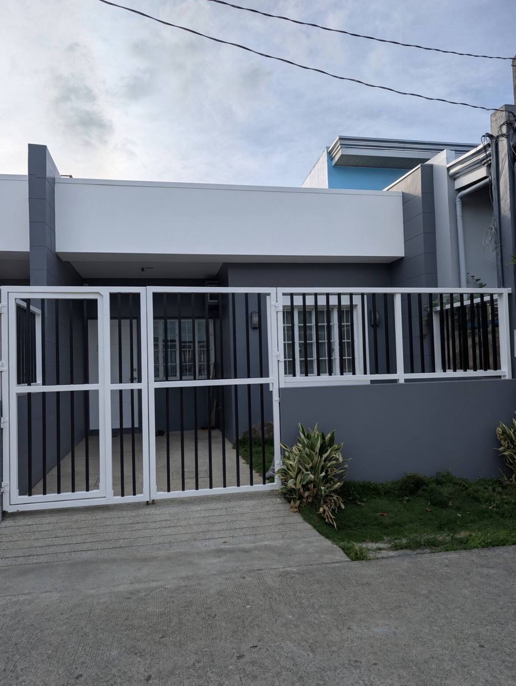 Front of the duplex with white gate